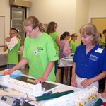 Green camper working on her wings